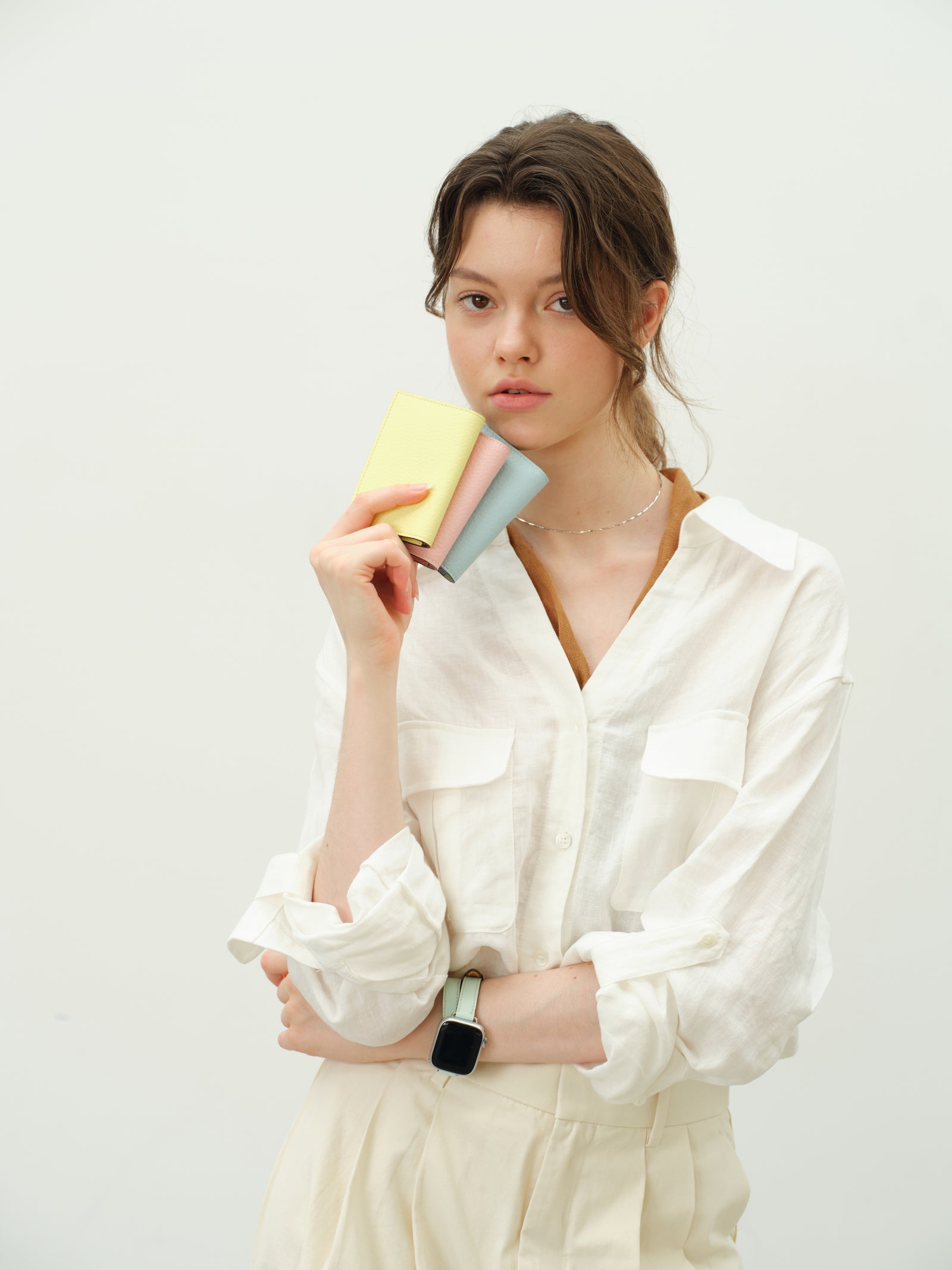 Cardholders in lemon, pink and sky blue with a mint watch strap