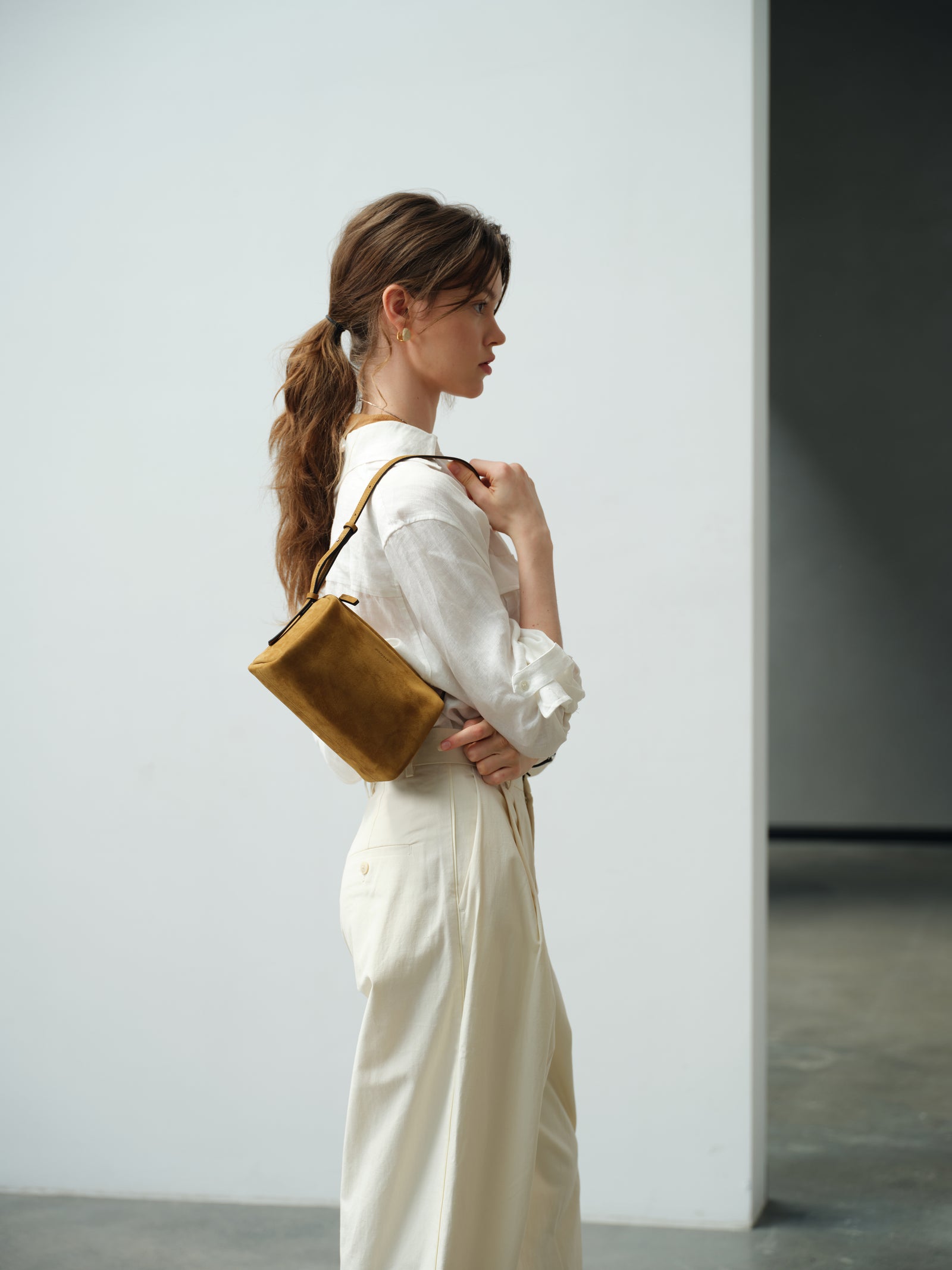 Ochre nubuck JOCQUELINE bag worn on the shoulder